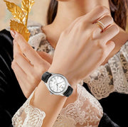Steel watch on a wrist with lace sleeve