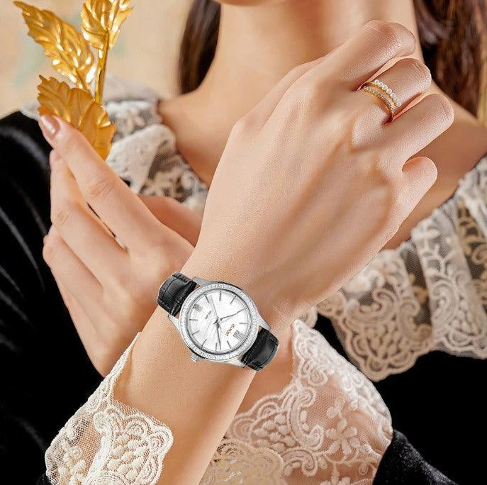 Steel watch on a wrist with lace sleeve