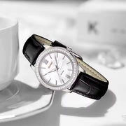 Steel watch resting on a table
