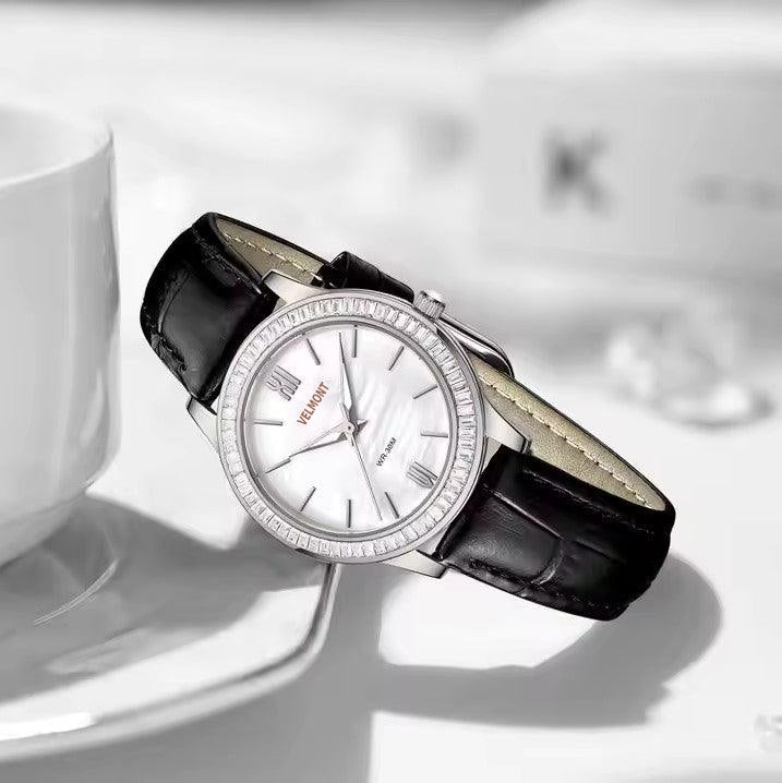 Steel watch resting on a table