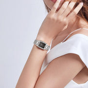 Steel watch worn on a raised wrist