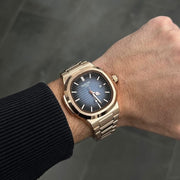 Blue dial watch on the wrist