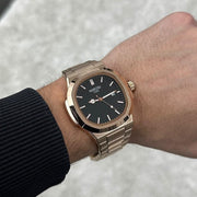 Black dial watch on a wrist, other angle