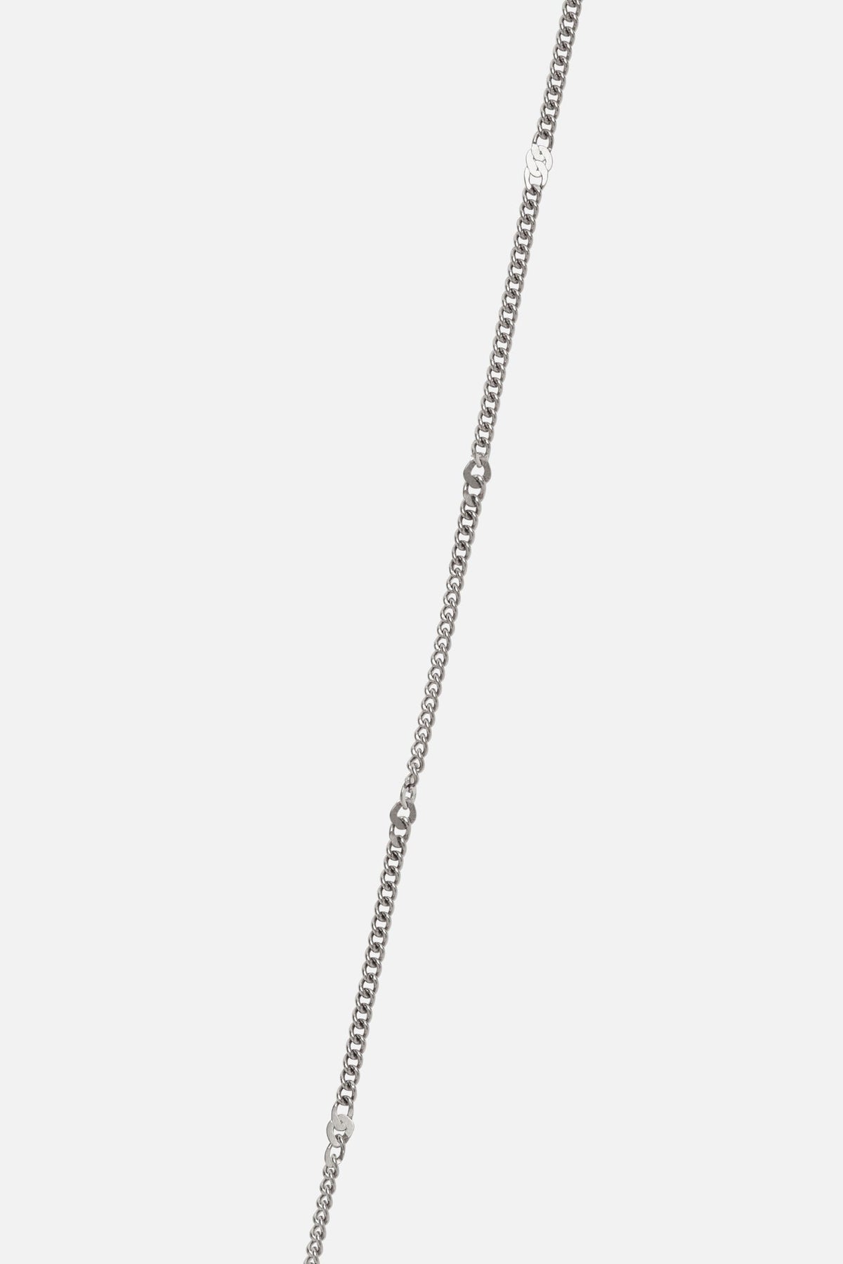Detail of the fine silver-tone curb chain with small bar details