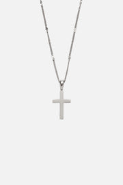 Silver-tone cross pendant on a fine chain, close-up