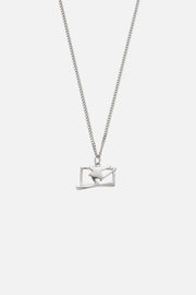 Silver-tone ski jumper pendant necklace, front view on a light background