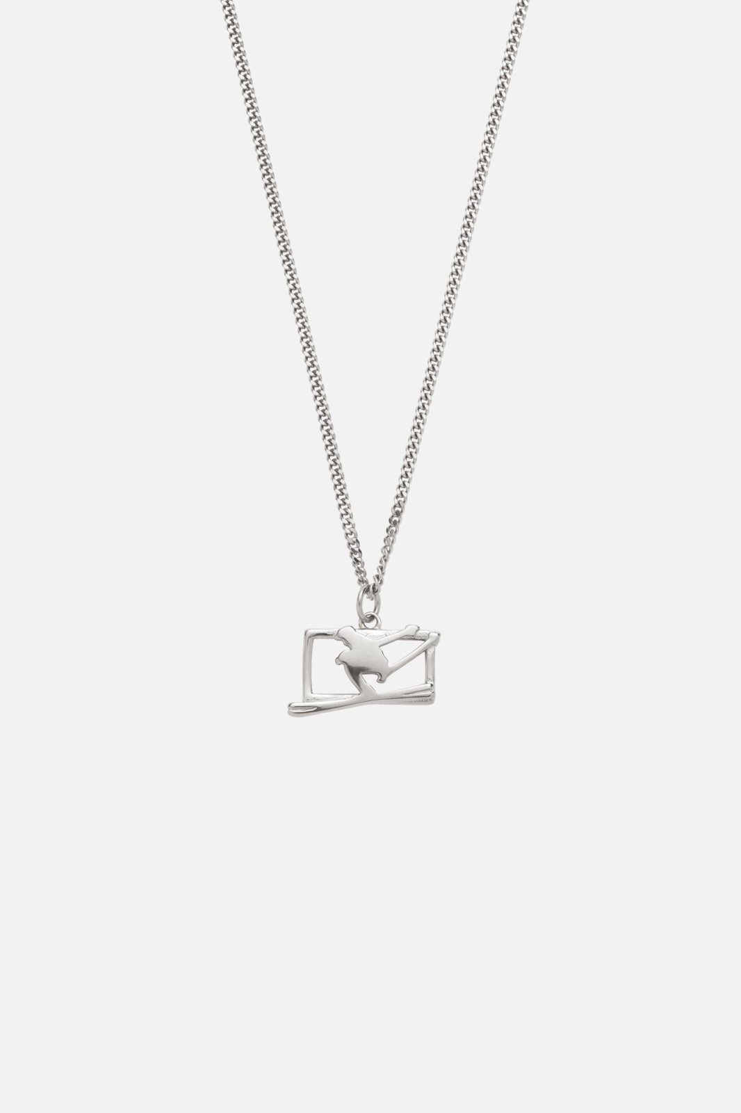 Silver-tone ski jumper pendant necklace, front view on a light background