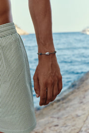 Brown cord bracelet with a white bead, view 2 of 6