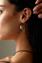 Close-up of the drop earring worn on the ear