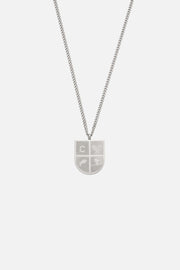 Silver-tone shield pendant necklace, front view on a light background