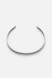 Silver-tone smooth rounded cuff, front view on a light background