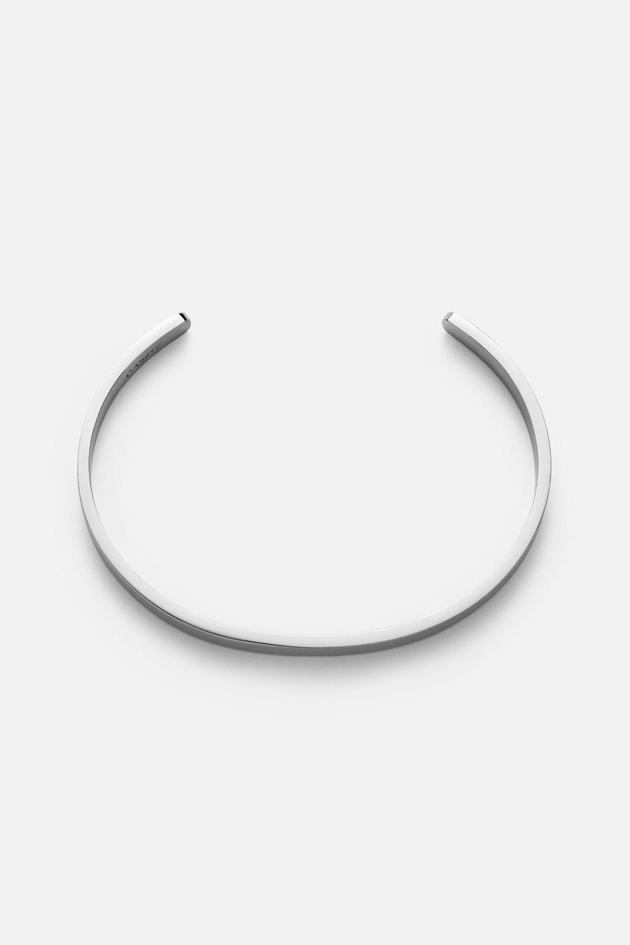 Silver-tone smooth rounded cuff, front view on a light background