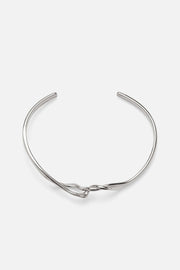 Silver-tone crossover twisted cuff, front view on a light background