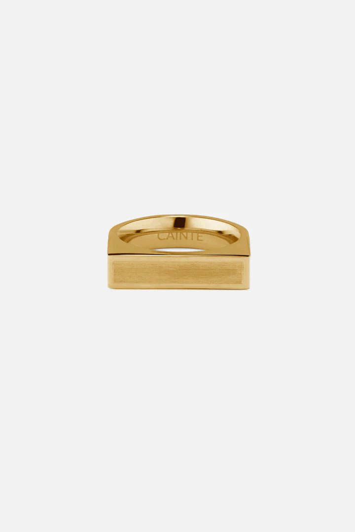 Gold-tone wide flat-top signet ring, front view on a light background