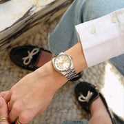 Worn with a white shirt cuff and jeans, black boat shoes in the background.