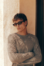 Man with arms crossed wearing the sunglasses