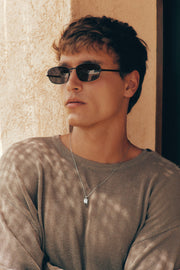 Man wearing the thin black sunglasses