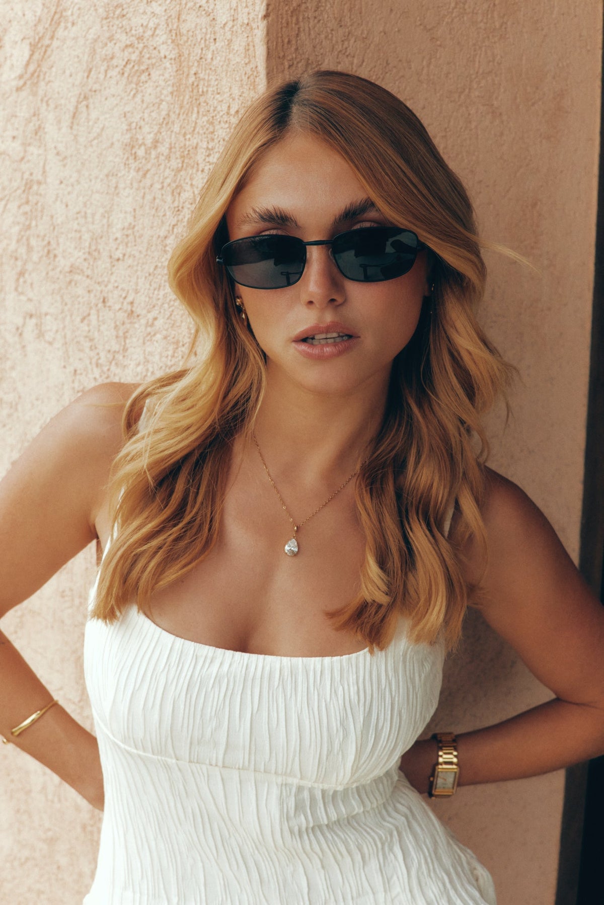 Woman wearing the thin black sunglasses, front view