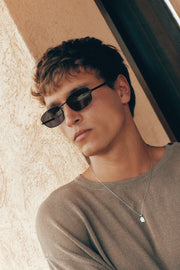 Man tilting his head wearing the sunglasses