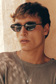Close-up of a man wearing the cat eye sunglasses