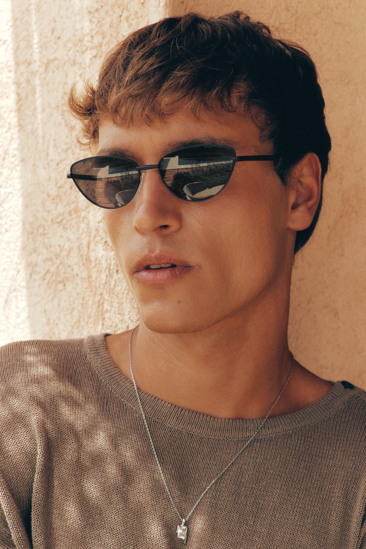 Close-up of a man wearing the cat eye sunglasses