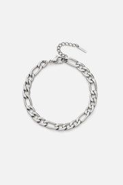 Silver-tone figaro chain bracelet, front view on a light background