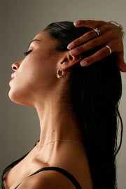 Model with her hand in her hair wearing the hoop