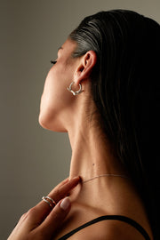 Model in profile wearing the wave hoop