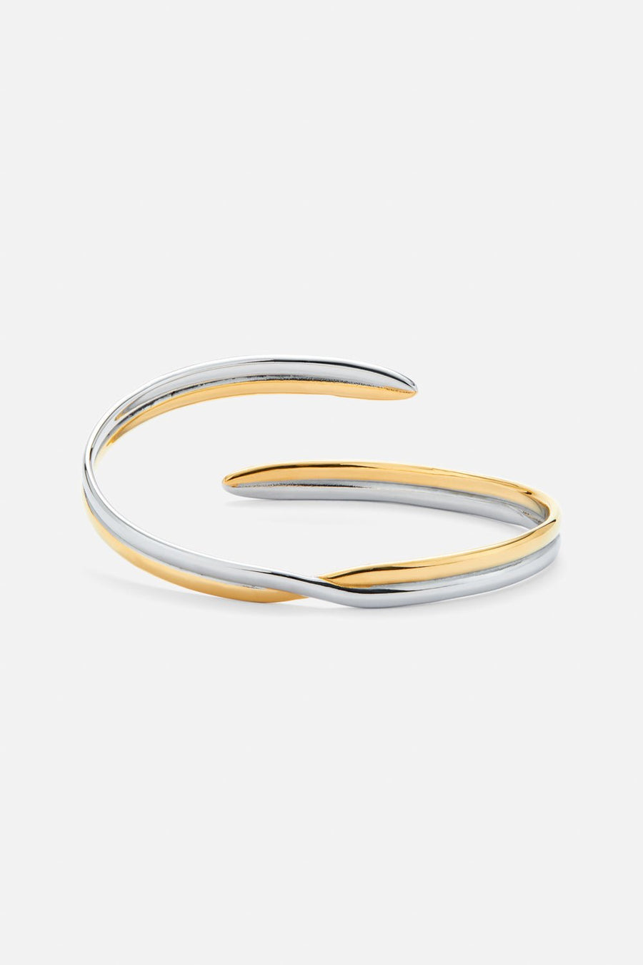 Two-tone crossover cuff bracelet, front view on a light background