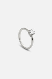 Silver-tone solitaire ring with a clear stone, front view on a light background