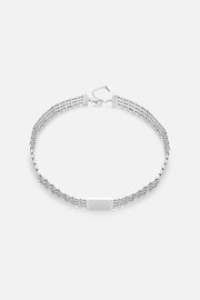 Silver-tone layered chain necklace, front view on a light background