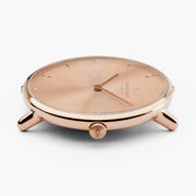 Profile of the watch head in rose gold-tone, crown facing the camera.