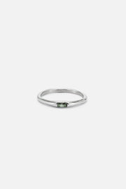 Thin band ring with a tiny green stone, front view