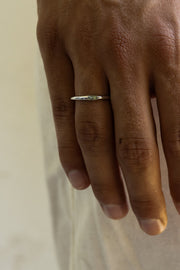 Close-up of the thin ring on the finger