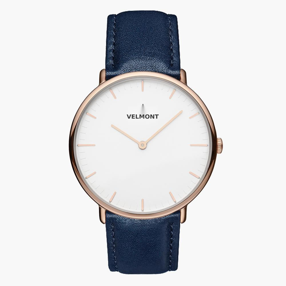 White-dial watch with a rose gold-tone case on a smooth navy strap.